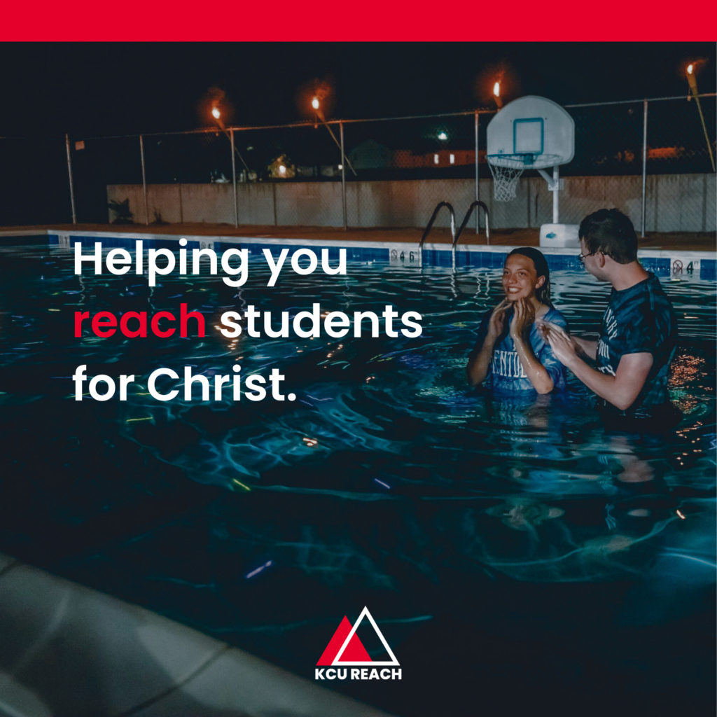 Two people stand waist-deep in a pool at night, with the text "Helping you reach students for Christ." visibly overlaid. A basketball hoop is in the background, and the KCU Reach logo is at the bottom.